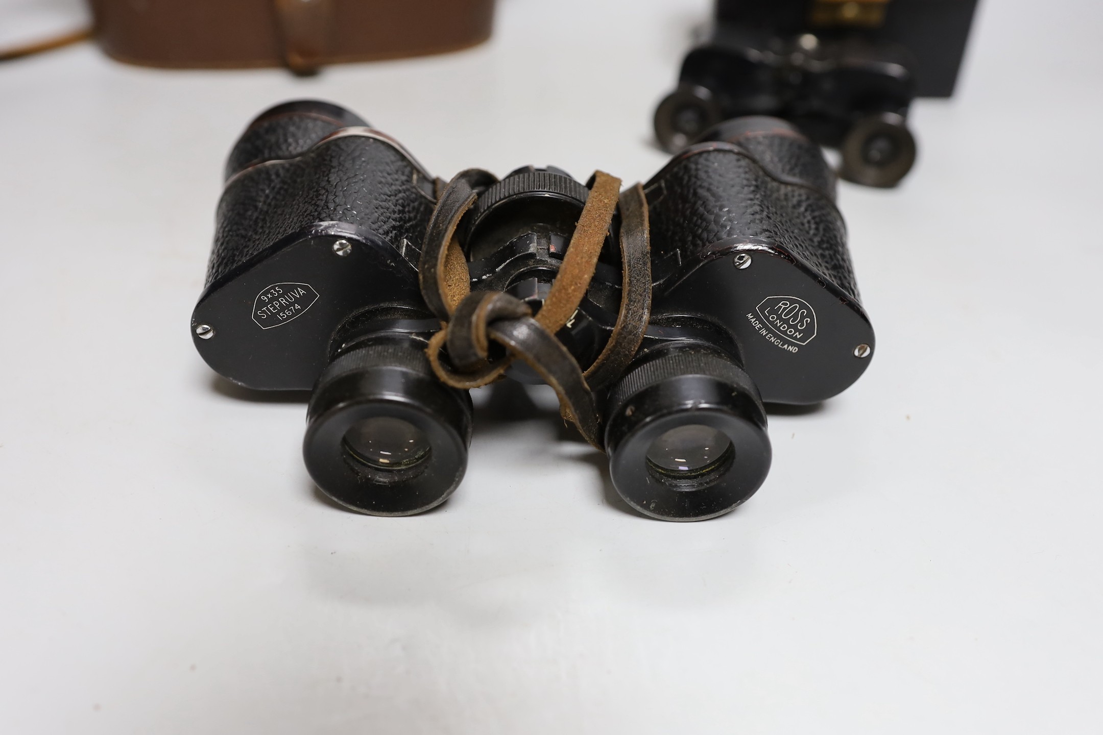 A cased set of Ross binoculars and a smaller cased set for racing